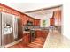 Kitchen boasts stainless appliances, granite countertops, hardwood floors, and wood cabinets at 8530 Ardennes Dr, Fishers, IN 46038