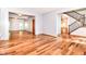 Open-concept living area with hardwood floors, a staircase, and a glimpse of the dining room at 8530 Ardennes Dr, Fishers, IN 46038