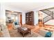 Comfortable living room with hardwood floors, sofas, area rug, and a glimpse of dining area at 8530 Ardennes Dr, Fishers, IN 46038