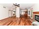 Large living room showcasing hardwood floors, a fireplace, and easy access to the kitchen and other areas of the home at 8530 Ardennes Dr, Fishers, IN 46038