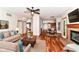 Spacious living room featuring hardwood floors, a ceiling fan, and an open layout leading to the dining area at 8530 Ardennes Dr, Fishers, IN 46038