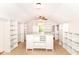 Spacious walk-in closet with custom shelving, a center island, and natural light from a nearby window at 8530 Ardennes Dr, Fishers, IN 46038