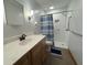 Updated bathroom features a modern vanity, updated fixtures, and a tiled walk-in shower with grab bars at 8711 E 296Th St, Atlanta, IN 46031