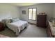 Bright bedroom featuring carpet, a window with light curtains, and classic wood furniture at 8711 E 296Th St, Atlanta, IN 46031