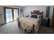 Cozy bedroom with a comfortable bed, soft carpet, and natural light streaming through sheer curtains at 8711 E 296Th St, Atlanta, IN 46031