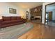 Cozy living room featuring a brick fireplace and hardwood floors at 8711 E 296Th St, Atlanta, IN 46031