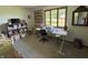 Spacious craft room featuring large windows, ample storage, a sewing desk and a large crafting table at 8711 E 296Th St, Atlanta, IN 46031