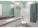 Well-lit bathroom featuring a single vanity, toilet, and shower with a curtain at 9718 Haughton Ln, McCordsville, IN 46055