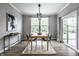 Elegant dining room featuring modern lighting, large windows, and access to outdoor at 9718 Haughton Ln, McCordsville, IN 46055
