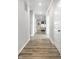 Long hallway with wood flooring, white trim, and recessed lighting leading to living area at 9718 Haughton Ln, McCordsville, IN 46055