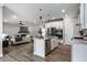 Bright, open-concept kitchen with stainless steel appliances, island, and seamless flow to living space at 9718 Haughton Ln, McCordsville, IN 46055