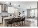 Open kitchen with white cabinets, granite countertops, island with seating, and stainless steel appliances at 9718 Haughton Ln, McCordsville, IN 46055