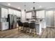 Modern kitchen with white cabinetry, stainless steel appliances, and center island with bar stools at 9718 Haughton Ln, McCordsville, IN 46055