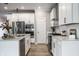 Bright kitchen with stainless steel appliances, granite countertops, and white cabinetry at 9718 Haughton Ln, McCordsville, IN 46055