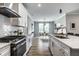 Open concept kitchen with an island overlooking dining area and stainless steel appliances at 9718 Haughton Ln, McCordsville, IN 46055