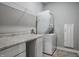 Efficient laundry room with counter space, storage, and stacked washer and dryer at 9718 Haughton Ln, McCordsville, IN 46055