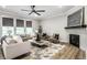 Cozy living room featuring a fireplace, modern furniture, and a large area rug at 9718 Haughton Ln, McCordsville, IN 46055