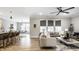 Open-concept living room with kitchen bar, neutral decor, and lots of natural light at 9718 Haughton Ln, McCordsville, IN 46055