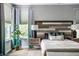 Relaxing bedroom with a decorative wall, plants, and bedside lamps on nightstands at 9718 Haughton Ln, McCordsville, IN 46055