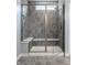 Modern tiled shower with built-in seating, shower head, and glass door enclosure at 9718 Haughton Ln, McCordsville, IN 46055