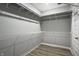 Walk-in closet with metal shelving, rods, and wood-style flooring at 9718 Haughton Ln, McCordsville, IN 46055