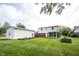 Wide backyard featuring garden beds, lawn, privacy fence and garage at 10244 Washington Blvd, Carmel, IN 46280