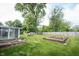 Garden beds, lawn, mature trees, and outdoor storage shed at 10244 Washington Blvd, Carmel, IN 46280