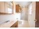 Bathroom featuring a vanity, toilet, storage cabinet, sink and glass door shower at 10244 Washington Blvd, Carmel, IN 46280