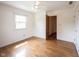 Bedroom featuring hardwood floors, a closet, a ceiling fan, and natural light from a window at 10244 Washington Blvd, Carmel, IN 46280