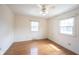 Bedroom featuring hardwood floors, a ceiling fan, and natural light from windows at 10244 Washington Blvd, Carmel, IN 46280