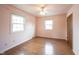 Cozy bedroom with hardwood floors, two windows allowing natural light, and a closet for storage at 10244 Washington Blvd, Carmel, IN 46280