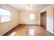 Bedroom featuring hardwood floors, a ceiling fan, a closet, and natural light from windows at 10244 Washington Blvd, Carmel, IN 46280