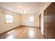 Spacious bedroom with hardwood floors, a ceiling fan, a closet, and natural light from two windows at 10244 Washington Blvd, Carmel, IN 46280