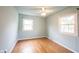 Light blue bedroom featuring hardwood floors, ceiling fan and windows with natural light at 10244 Washington Blvd, Carmel, IN 46280