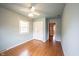 Bedroom featuring hardwood floors, ceiling fan, closet, and windows for natural light at 10244 Washington Blvd, Carmel, IN 46280