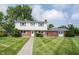 Charming two-story home boasts a brick and vinyl exterior with a well-manicured lawn at 10244 Washington Blvd, Carmel, IN 46280