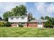 Charming two-story home featuring a brick and siding exterior, manicured lawn, and classic architectural details at 10244 Washington Blvd, Carmel, IN 46280