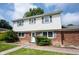 Charming two-story home featuring brick and siding, complemented by shutters and landscaped yard at 10244 Washington Blvd, Carmel, IN 46280