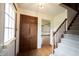 Inviting foyer features hardwood floors, a staircase, and a double-door closet at 10244 Washington Blvd, Carmel, IN 46280