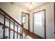 Bright foyer features hardwood floors, a staircase, and a white front door at 10244 Washington Blvd, Carmel, IN 46280