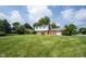 Expansive front yard of a two-story home with mature trees, showcasing curb appeal and lawn at 10244 Washington Blvd, Carmel, IN 46280