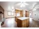 Open kitchen boasts an island, hardwood floors, and views into the living area at 10244 Washington Blvd, Carmel, IN 46280