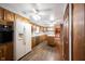 Charming kitchen featuring wooden cabinets, white appliances, island, and refrigerator at 10244 Washington Blvd, Carmel, IN 46280