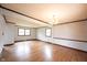 Open living area with chandelier lighting, wood floors, and lots of natural light at 10244 Washington Blvd, Carmel, IN 46280
