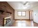 Bright living room with brick fireplace, hardwood floors, and large windows at 10244 Washington Blvd, Carmel, IN 46280