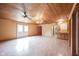 Bright living space with a wood ceiling, hardwood floors, built-in shelves and cabinet, and a wet bar at 10244 Washington Blvd, Carmel, IN 46280