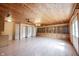 Spacious living area featuring wood ceiling, ceiling fans, built-in shelves, and plenty of natural light at 10244 Washington Blvd, Carmel, IN 46280