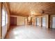 Open living area with a wood ceiling, hardwood floors, built-in shelves and cabinet, and wet bar at 10244 Washington Blvd, Carmel, IN 46280
