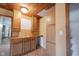 Functional wet bar area with wood cabinetry, sink, countertop space, and additional storage cabinets at 10244 Washington Blvd, Carmel, IN 46280