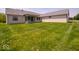 Expansive backyard features lush green grass and a covered patio at 10586 Jacks Way, Indianapolis, IN 46234